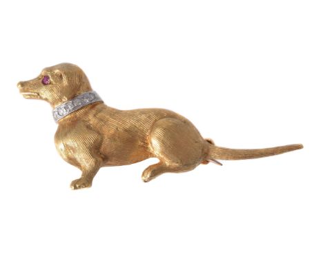 A 1960s diamond and ruby dachshund brooch, the seated dog with textured coat, with eight cut diamond set collar and a circula
