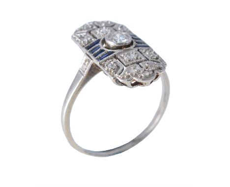 An Art Deco sapphire and diamond panel ring, circa 1920, the central brilliant cut diamond approximately 0.10 carats between 