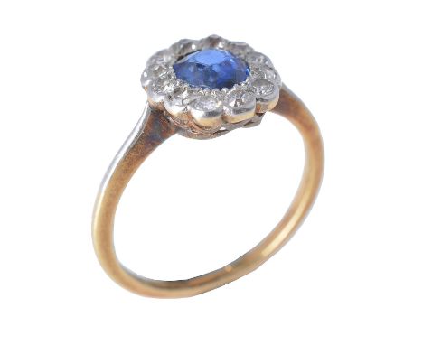 An early 20th century sapphire and diamond cluster ring, circa 1920, the oval cut sapphire estimated to weigh 0.62 carats, wi
