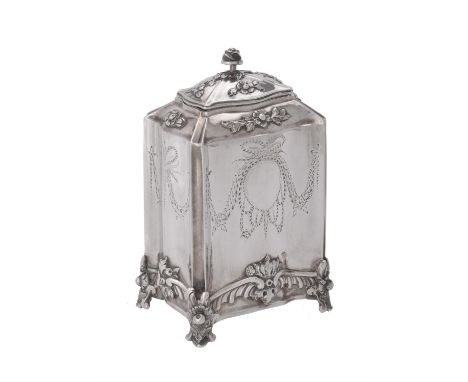 A Continental silver shaped rectangular tea caddy, unmarked, with a floral finial, the body chased and engraved with foliate 