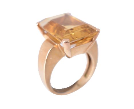 A Portuguese mid 20th century citrine dress ring, the step cut citrine with canted corners, to domed polished gold coloured s