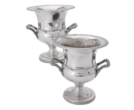 A pair of electro-plated campana shaped wine coolers, with gadrooned borders and twin loop handles, on a gadrooned circular m