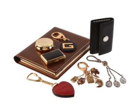 A collection of luxury accessories, to include: Asprey, a brown leather address book, opening to address pages, a notepad and