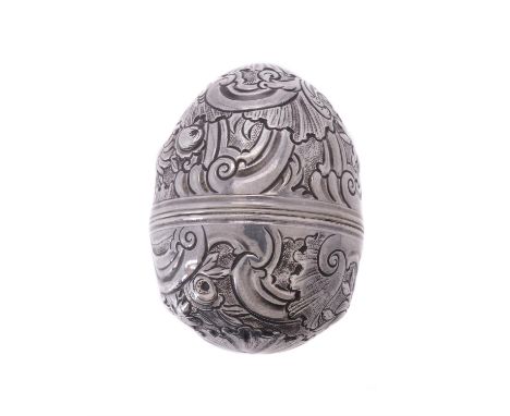 A silver coloured egg shaped nutmeg grater, unmarked, chased with C-scrolls, foliate swags and floral sprays, the screw down 