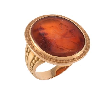 A French 19th century cornelian intaglio ring, the oval panel carved with the profile of a gentleman, possibly Aeschylus, wit