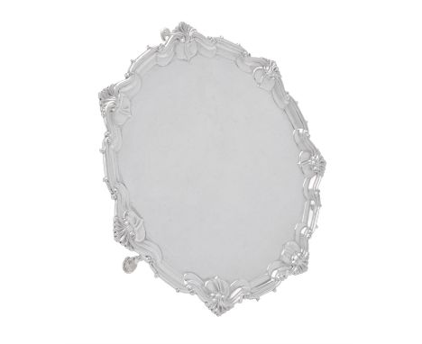 An Edwardian silver shaped circular salver by William Hutton & Sons Ltd., London 1908, with a foliate and scroll border, on t