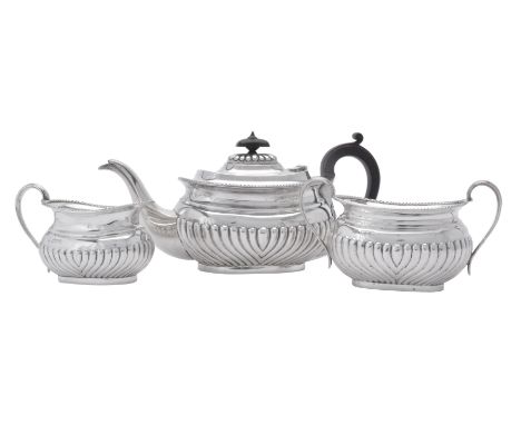 A late Victorian silver three piece oblong baluster tea set by Samuel Walton Smith, London 1898, the tea pot with a compositi