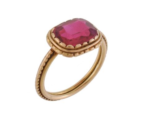 An early 20th century French synthetic ruby ring by G. Perret, circa 1900, the cushion cut ruby within a lobed collet setting