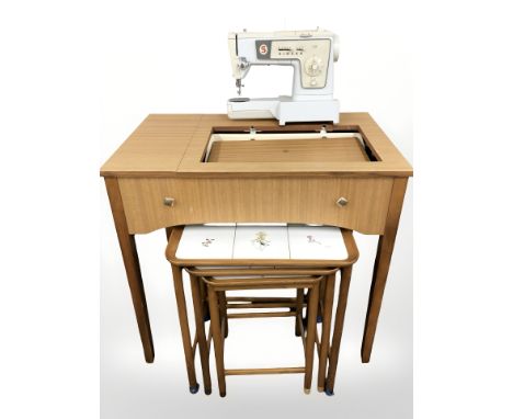 Singer 438 electric sewing machine in table and a nest of three tiled inset tables 