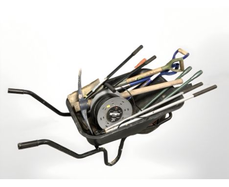 A wheel barrow of assorted garden tools and an extension reel 