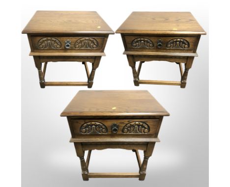 Three reproduction oak single drawer lamp tables, each 56 cm wide 