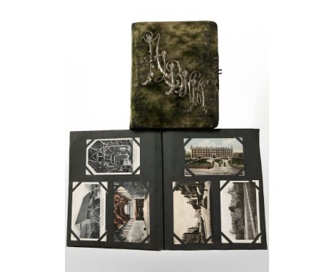 Two albums of antiquarian monochrome and colour postcards, portrait photographs, etc.