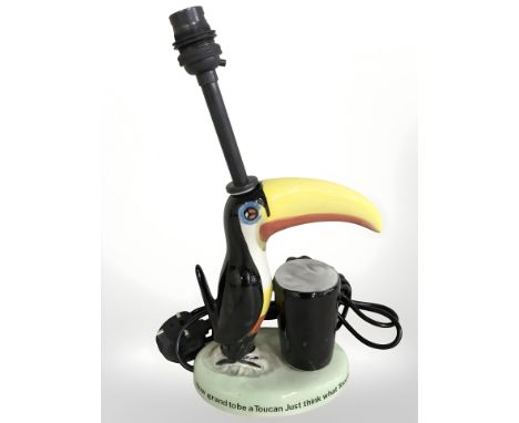 A reproduction Guinness toucan table lamp, height 33 cm including fitting.