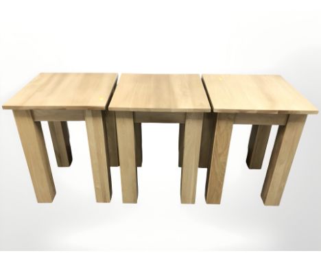 A set of three contemporary oak veneered lamp tables, width 45 cm.