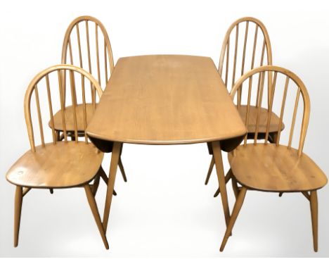 An Ercol elm and beech drop leaf dining table, width 113 cm, and two pairs of spindle back dining chairs 