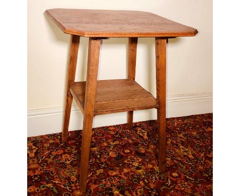 An Arts and Crafts oak hall table, octagonal form top, raised on tapered supports united with a shelf. 69cm H x 54cm W x 54cm