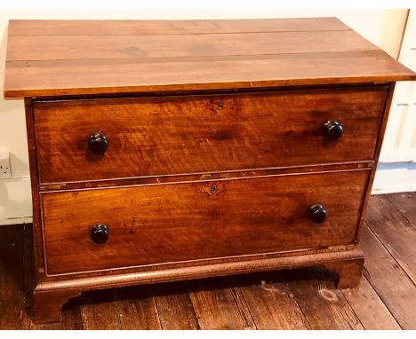 A George III mahogany low chest of drawers, oversailing three planked rectangular form top, over two long drawers with later 