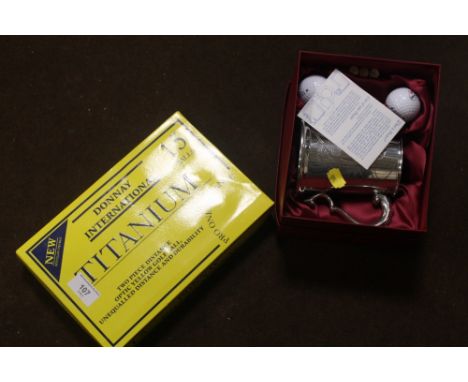 A BOX OF DONNAY INTERNATIONAL TITANIUM GOLF BALLS, TOGETHER WITH A BOXED SILVER PLATED GOLFING TANKARD 