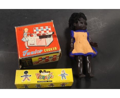A BOXED PELHAM GIRL PUPPET, A BOXED BRIMTOY TIN PLATE JUNIOR COOKER, AND A BLACK PLASTIC DOLL, ETC