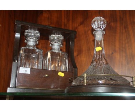 A TANTALUS TOGETHER WITH A LARGE CUT GLASS DECANTER