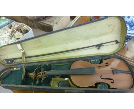 A violin, the two part black  14''L with a bow, in a fitted case        LAM