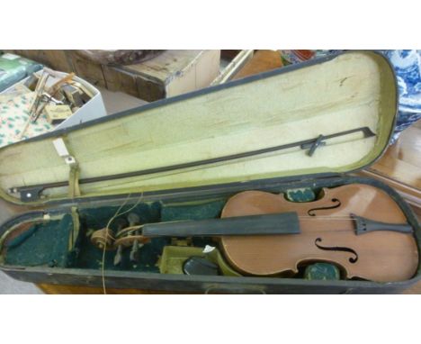 A violin, the two part black  14''L with a bow, in a fitted case        LAM