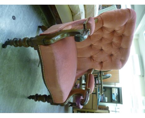 Late Victorian mahogany framed salon chair, having a red fabric button upholstered back and swept open arms, raised on turned