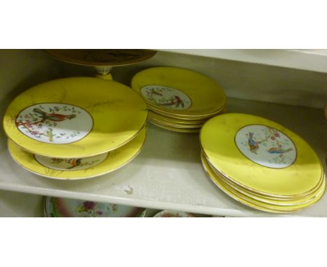 A Royal Worcester china dessert service, decorated with exotic birds and gilded, on a yellow ground; and a similar service Wo