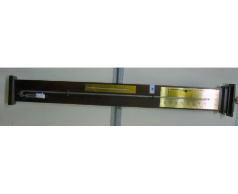 A modern stick barometer with lacquered gilded metal register plates, on a polished oak backplate  40''h        HSR