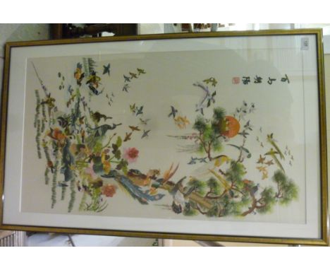 A modern Japanese multi-coloured silk tapestry picture, featuring exotic birds and wild fowl  35'' x 20'' in a strip frame   
