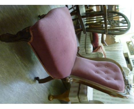 A late Victorian mahogany framed salon chair, the part button upholstered back and seat raised on cabriole legs         CA