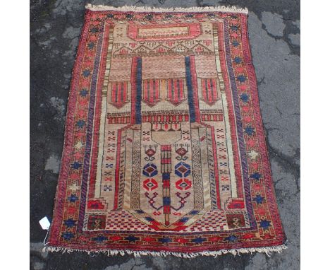 A BELOUCH PRAYER RUG with architectural motifs worked in reds and blue, 83 x 160cm (moth damaged)