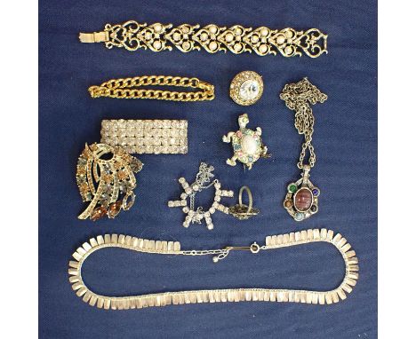 A COLLECTION OF COSTUME JEWELLERY including a fringe necklace; a square rhinestone brooch; a large concentric white stone bro