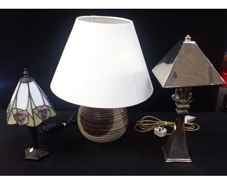 A SILVER COLOURED METAL TABLE LAMP on square tapering base, a Tiffany style lamp, and a studio pottery lamp (3)