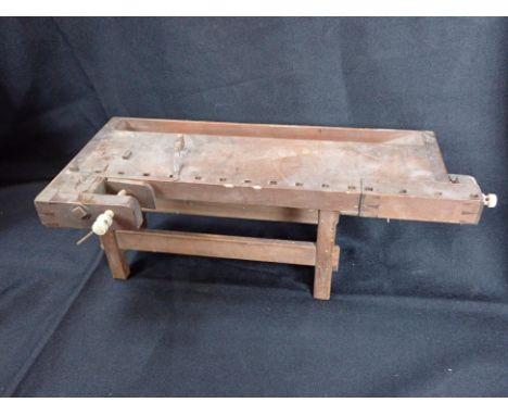 A 19TH CENTURY 'APPRENTICE' MODEL CARPENTER'S BENCH with two vices with bone screws, 33cm long (woodworm)