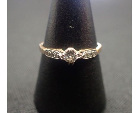 AN 18CT GOLD AND DIAMOND ENGAGEMENT RING the seven stones in channel setting