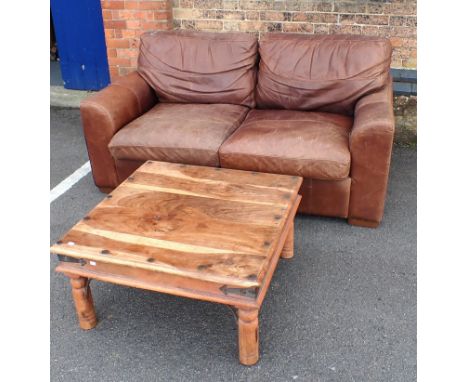 A MODERN LEATHER TWO-SEAT SOFA with patinated surface, 175cm wide, 90cm deep, and an Indian hardwood coffee table 80cm square