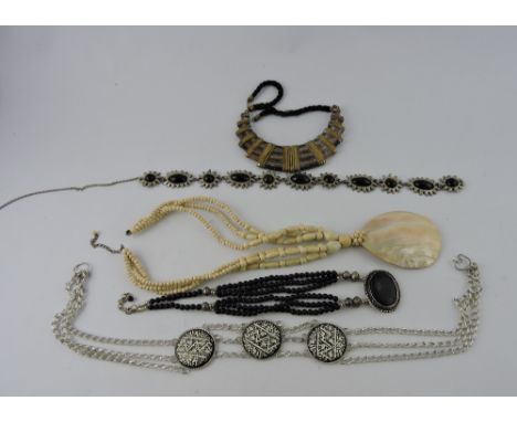 A quantity of assorted costume jewellery including large mother of pearl pendant necklace, faux pearl jet and coral necklaces