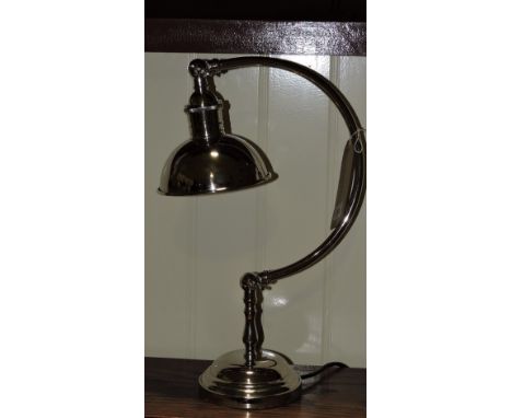 An Art Deco style nickel plated adjustable desk lamp with solid shade.