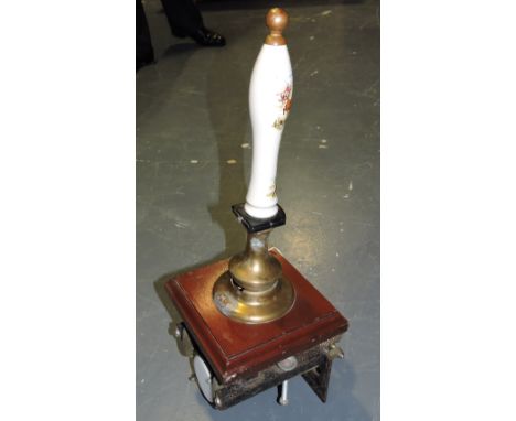 A vintage English brass mounted mahogany beer engine, the ceramic handle printed with a hunting scene H 58 cms