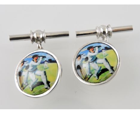 A pair of white metal and enamel cufflinks bearing images of cricketers and stamped 925.