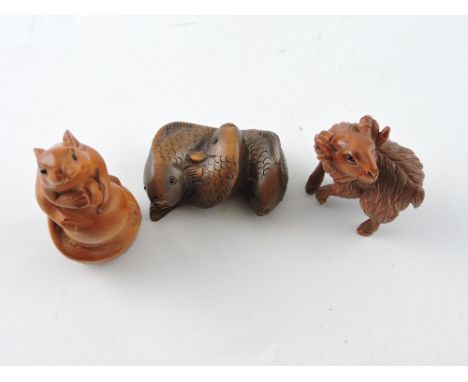 A a netsuke in the form of a rat atop a gourd, H. 6cm; together with a ram, and a three carp. (3)