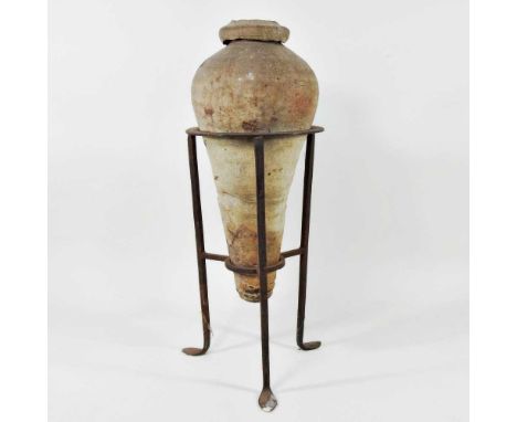 An ancient pottery amphora vase, possibly Roman, of typical form, mounted in an iron frame, 50cm high