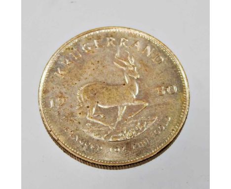 A South African krugerrand coin, dated 1980, 34gOverall condition is complete with light marks and dirty, small nibbles to th