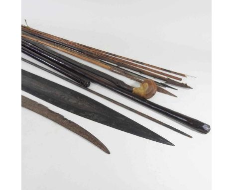 An African tribal spearhead, 116cm long, together with a hardwood club, various spears, clubs and a sword (11)