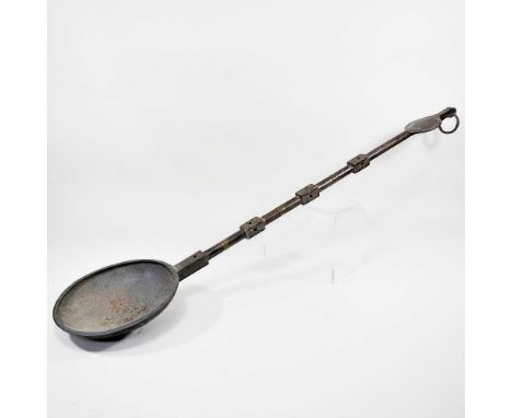 A large African tribal bronze ladle or scoop, with a circular bowl, 103cm long