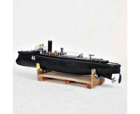 A large battery operated painted wooden model boat, 121cm long, on a wooden standOverall condition looks to be complete with 