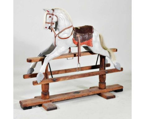A mid 20th century painted wooden rocking horse, on a trestle base132w x 42d x 106h cm