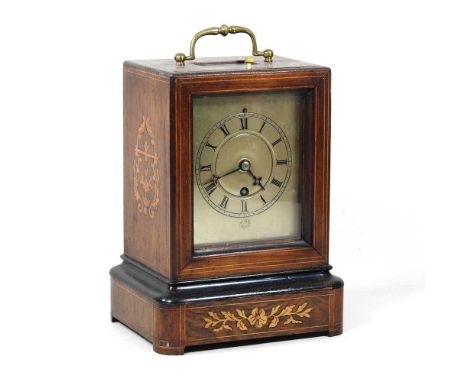 A 19th century rosewood and marquetry cased library clock, with a silvered dial, having a drum movement, 24cm high overall. N