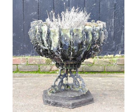An ornate painted cast metal garden planter, of pedestal form, 62cm high